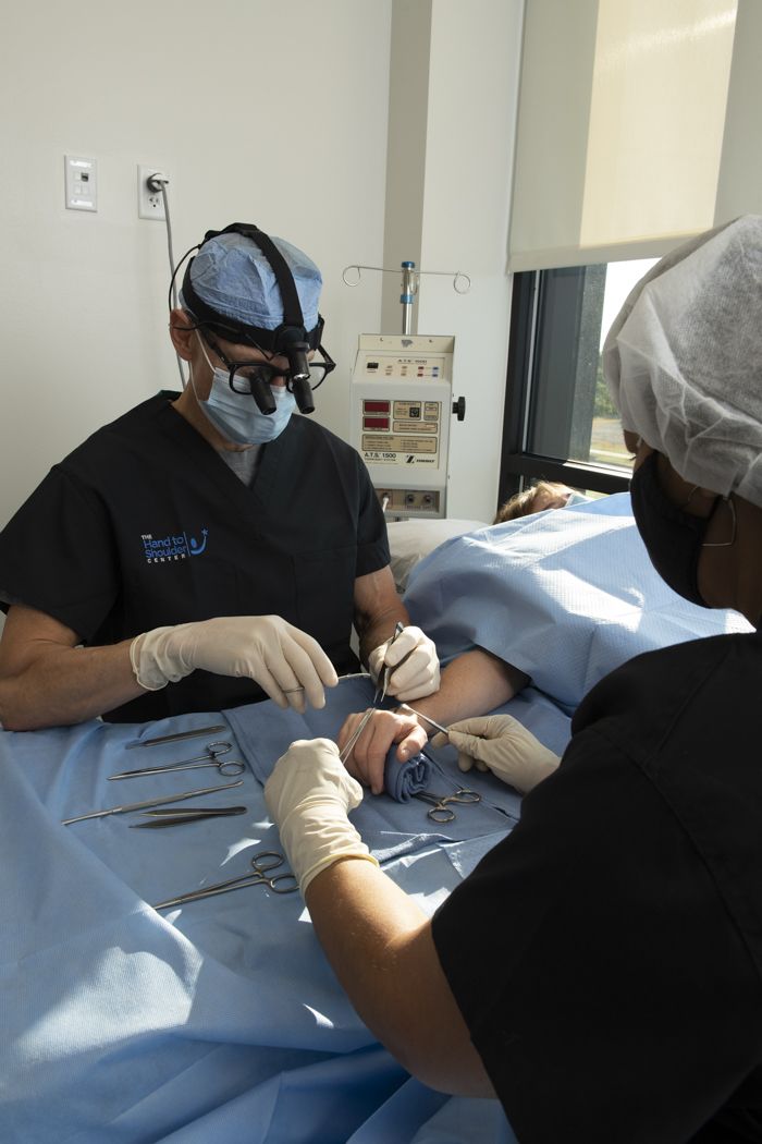 Hand surgeon operating on patient